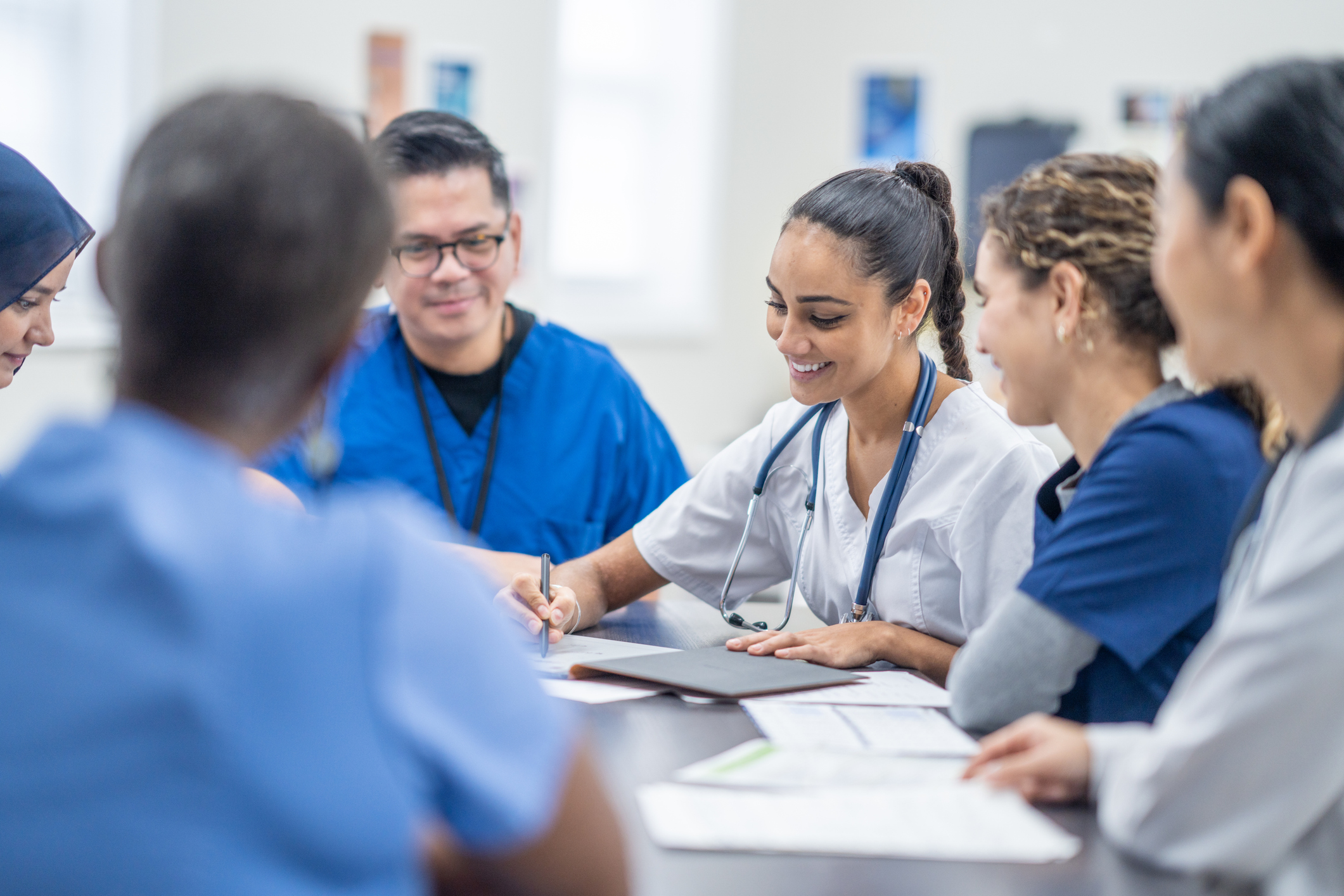 A group health professionals sat together in a meeting.