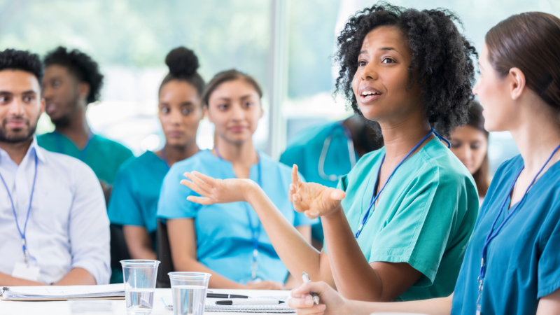 A group of health professionals in discussion.