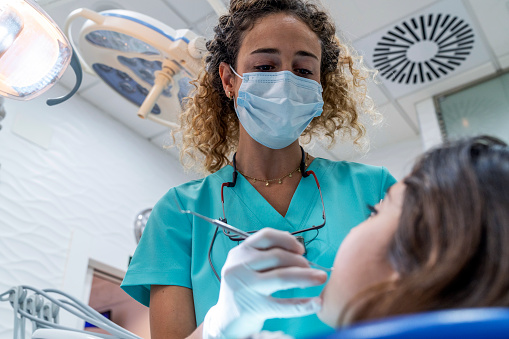 A Dental professional examining a patient